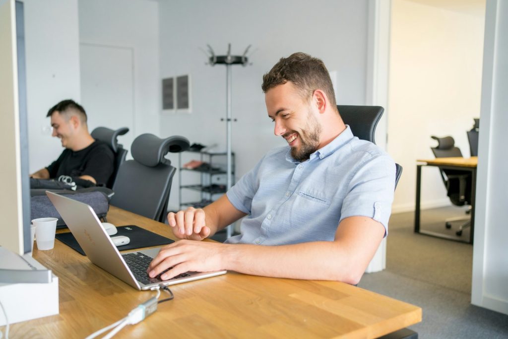 Man smiling at laptop